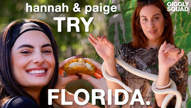 Two women with a snake and a food item.